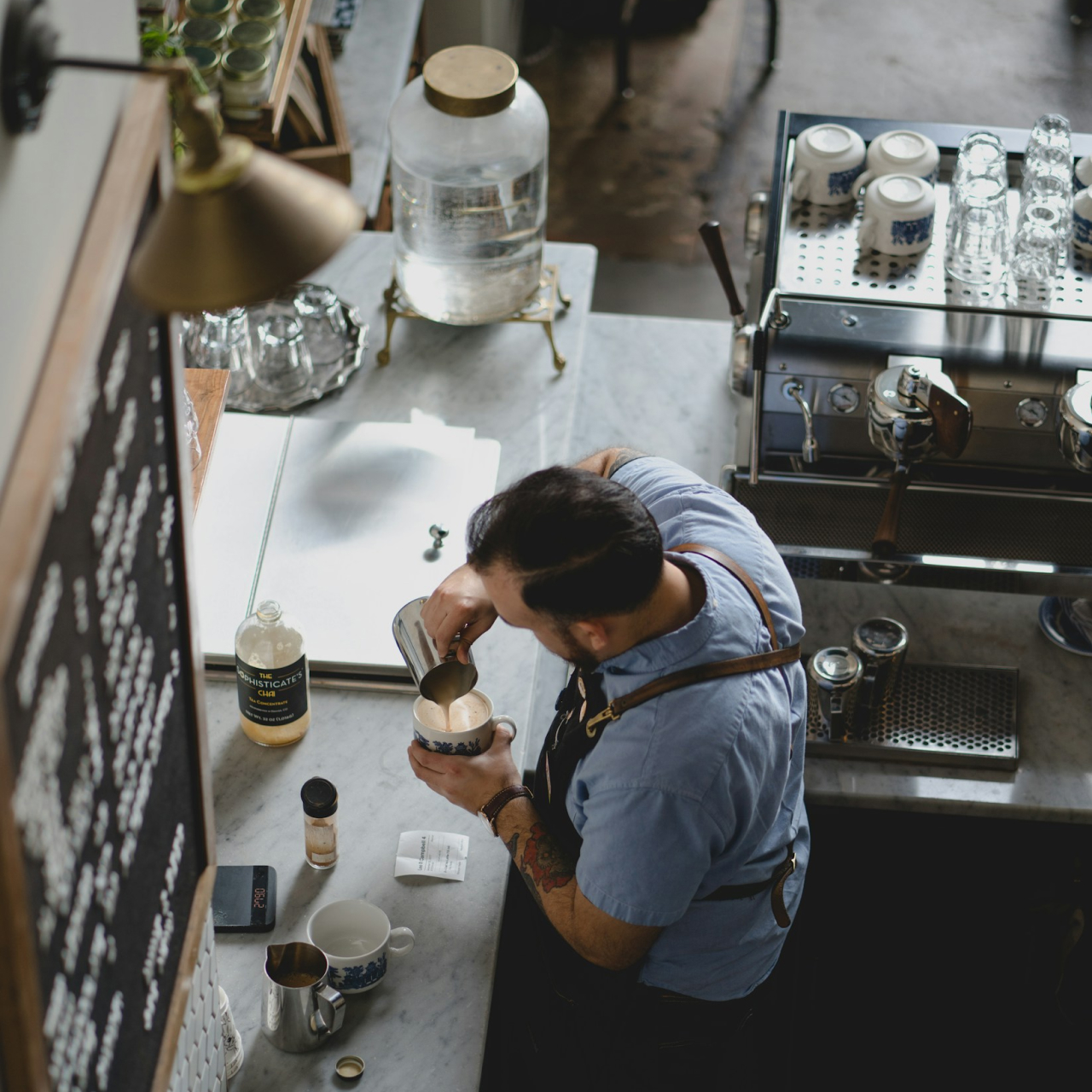 Barista crafting a cappuccino with latte art